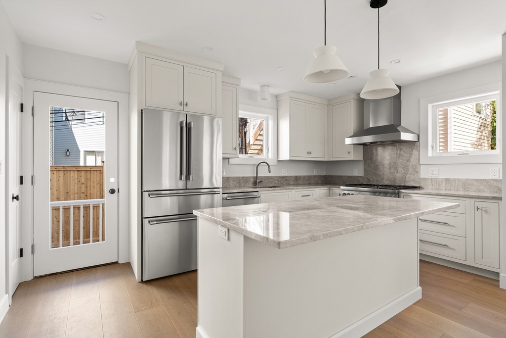9 Armory Street Boston, MA 02129 - Photo 2 of 37 a kitchen with stainless steel appliances granite countertop a refrigerator a stove a sink dishwasher and a refrigerator