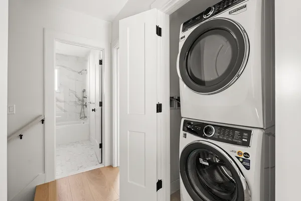a view of a hallway with washer and dryer