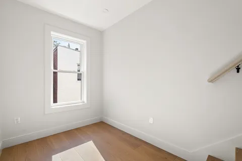 an empty room with windows and closet