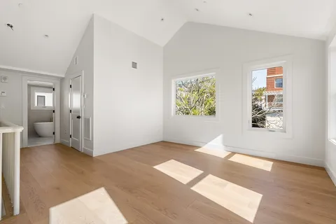 an empty room with windows and closet