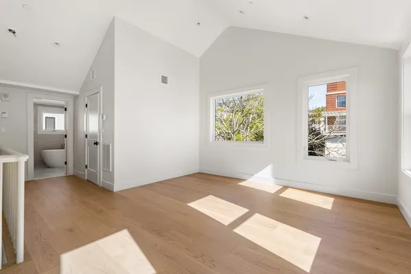 an empty room with windows and closet