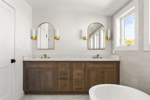 a bathroom with a toilet sink and mirror