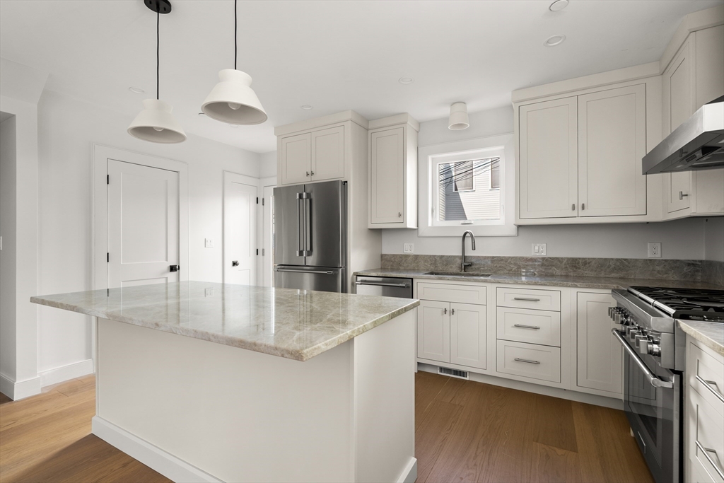 9 Armory Street Boston, MA 02129 - Photo 5 of 37 a kitchen with stainless steel appliances granite countertop a sink a stove and refrigerator
