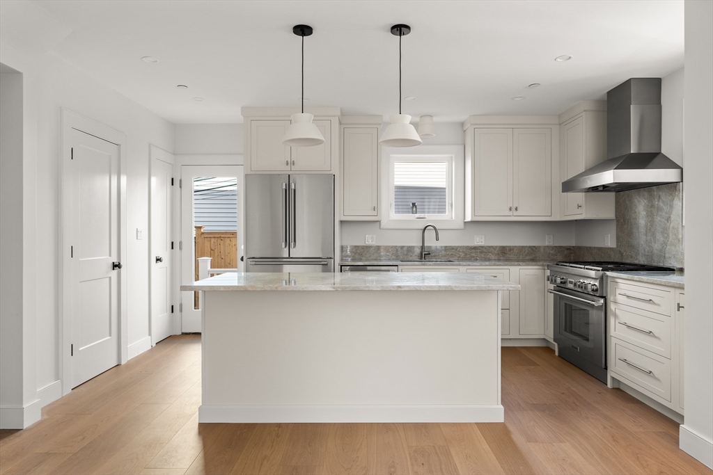 9 Armory Street Boston, MA 02129 - Photo 6 of 37 a kitchen with stainless steel appliances granite countertop a sink a stove and a wooden floors