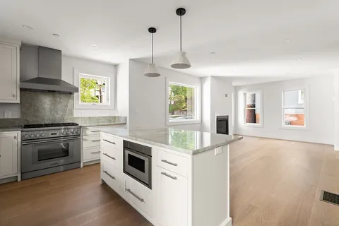 a kitchen with stainless steel appliances granite countertop a stove and a sink