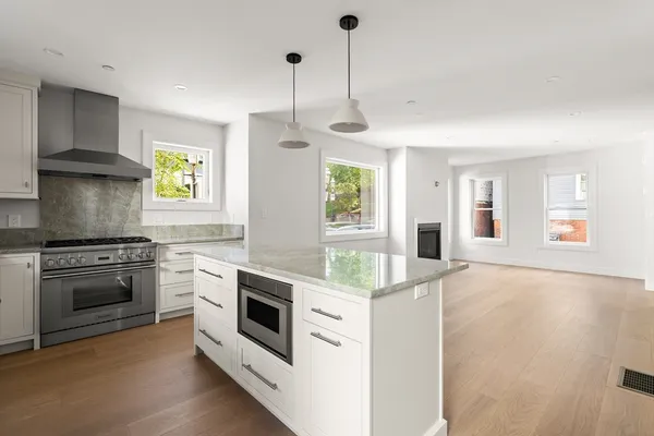 a kitchen with stainless steel appliances granite countertop a stove and a sink