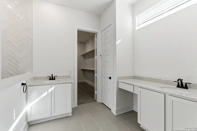 a view of a hallway to closet and utility room