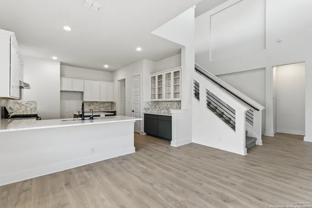 a large white kitchen with stainless steel appliances