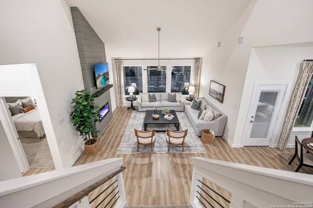 a living room with furniture large window and flat screen tv