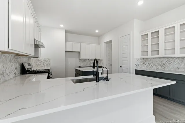 a kitchen with a sink stainless steel appliances and cabinets