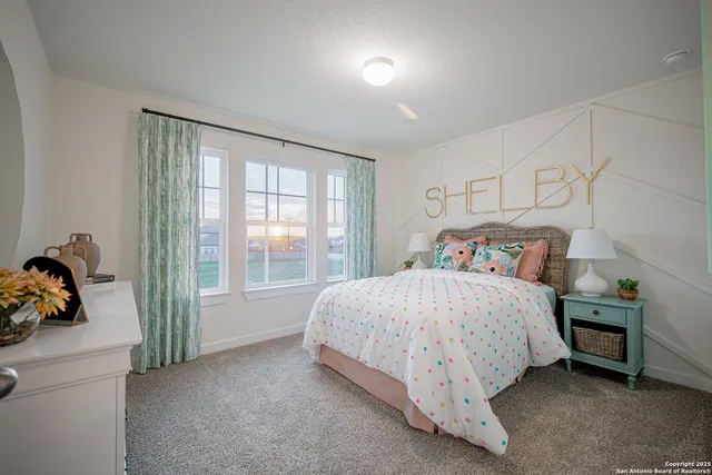 a bed sitting in a bedroom next to a window