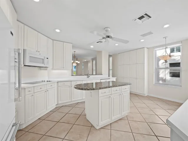 a kitchen with stainless steel appliances granite countertop a sink and cabinets