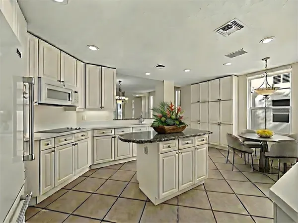 a kitchen with stainless steel appliances kitchen island granite countertop a sink and cabinets