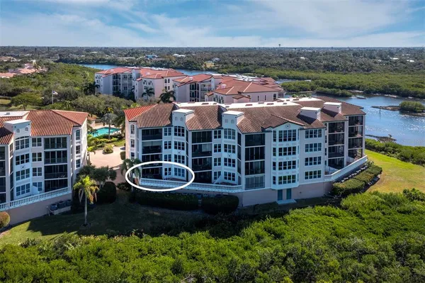 an aerial view of a house with a garden and lake view