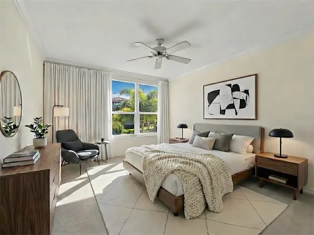 a spacious bedroom with a bed a couch and a window