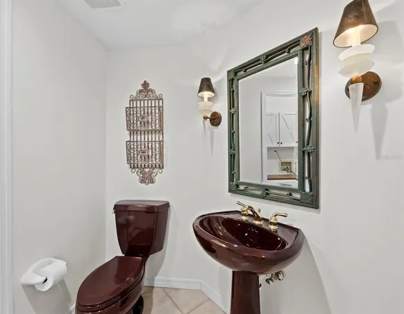 a bathroom with a toilet and a mirror