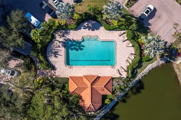 an aerial view of a house lake and outdoor space