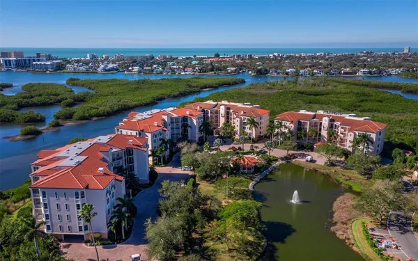an aerial view of residential houses with outdoor space and lake view