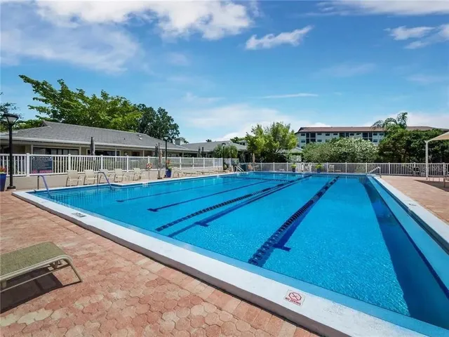 swimming pool with outdoor seating and plants