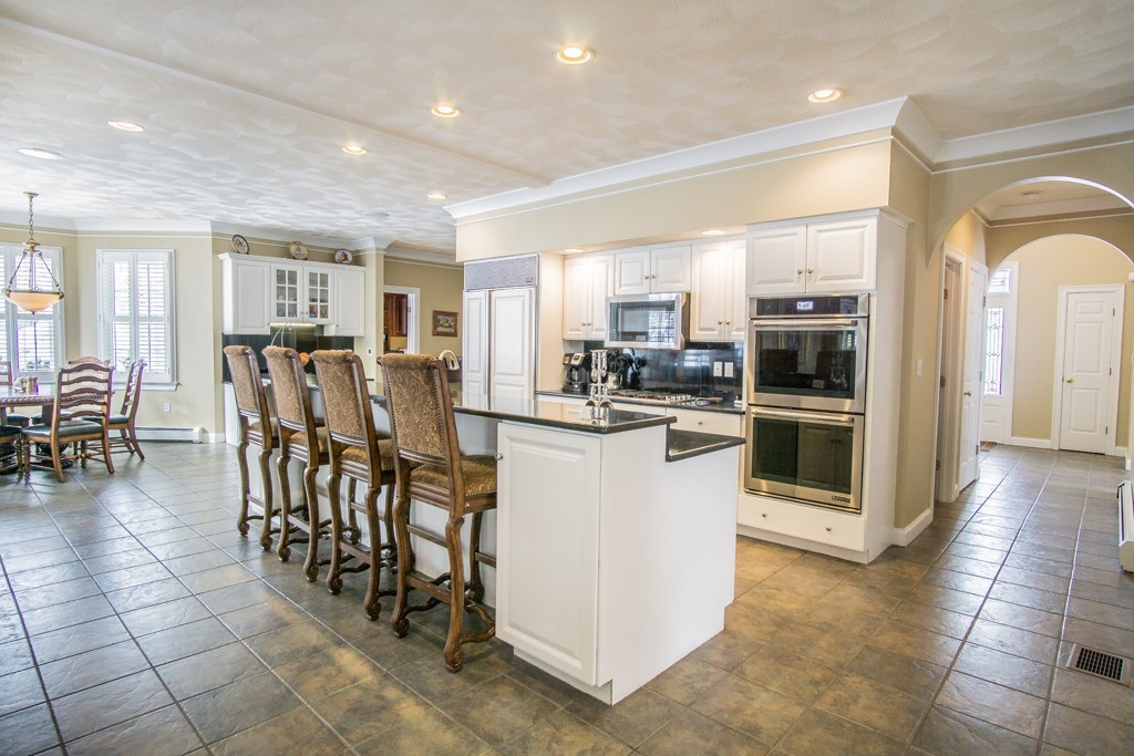 16 Somerset Drive Andover, MA 01810 - Photo 4 of 30 a kitchen with stainless steel appliances kitchen island granite countertop a refrigerator and cabinets