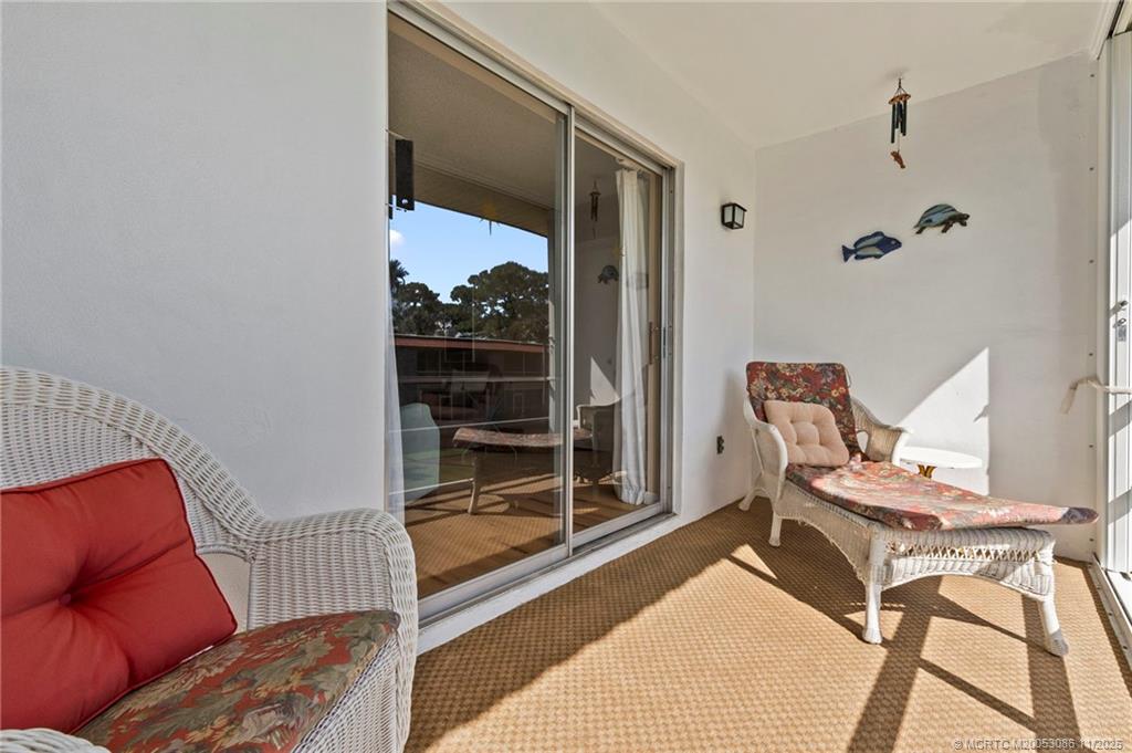 1951 Southwest Palm City Road, Unit 26F Stuart, FL 34994 - Photo 11 of 20 a living room with a couch and a window