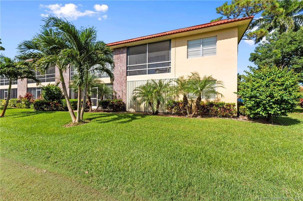 1951 Southwest Palm City Road, Unit 26F Stuart, FL 34994 - Photo 13 of 20 a front view of house with yard and green space
