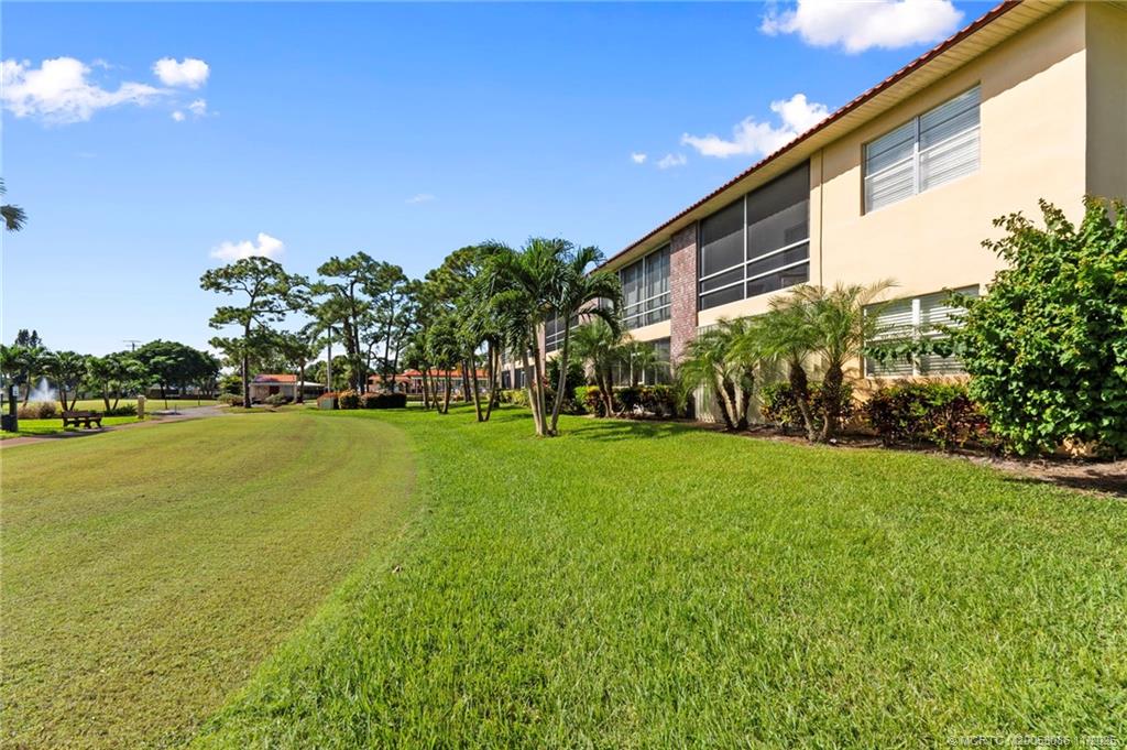 1951 Southwest Palm City Road, Unit 26F Stuart, FL 34994 - Photo 14 of 20 a view of an house with backyard space and garden