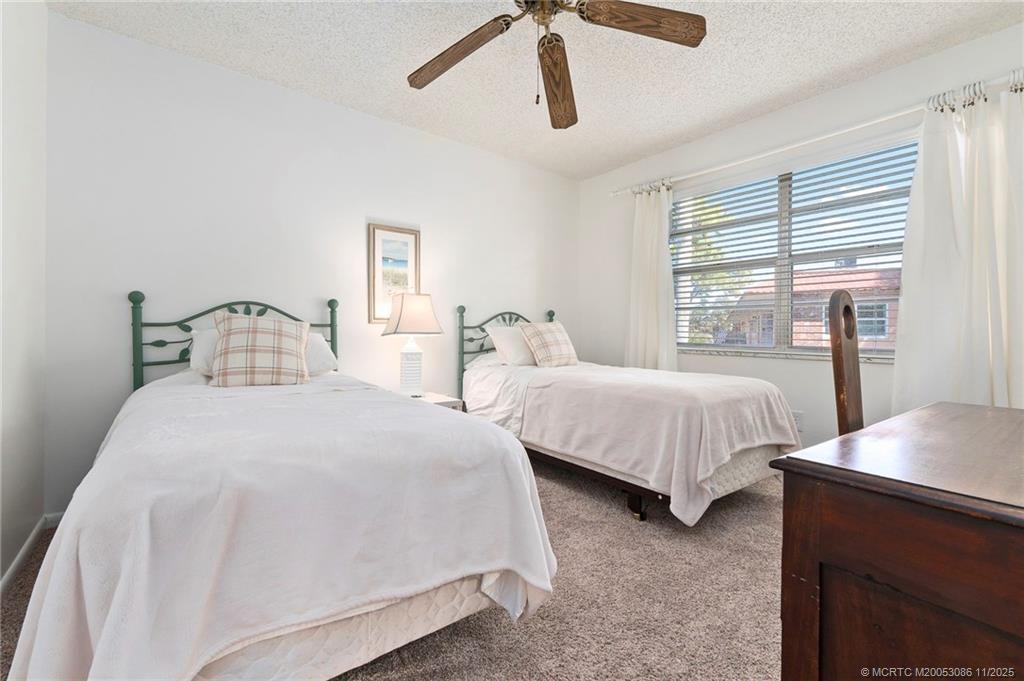 1951 Southwest Palm City Road, Unit 26F Stuart, FL 34994 - Photo 8 of 20 a bedroom with two beds and white walls
