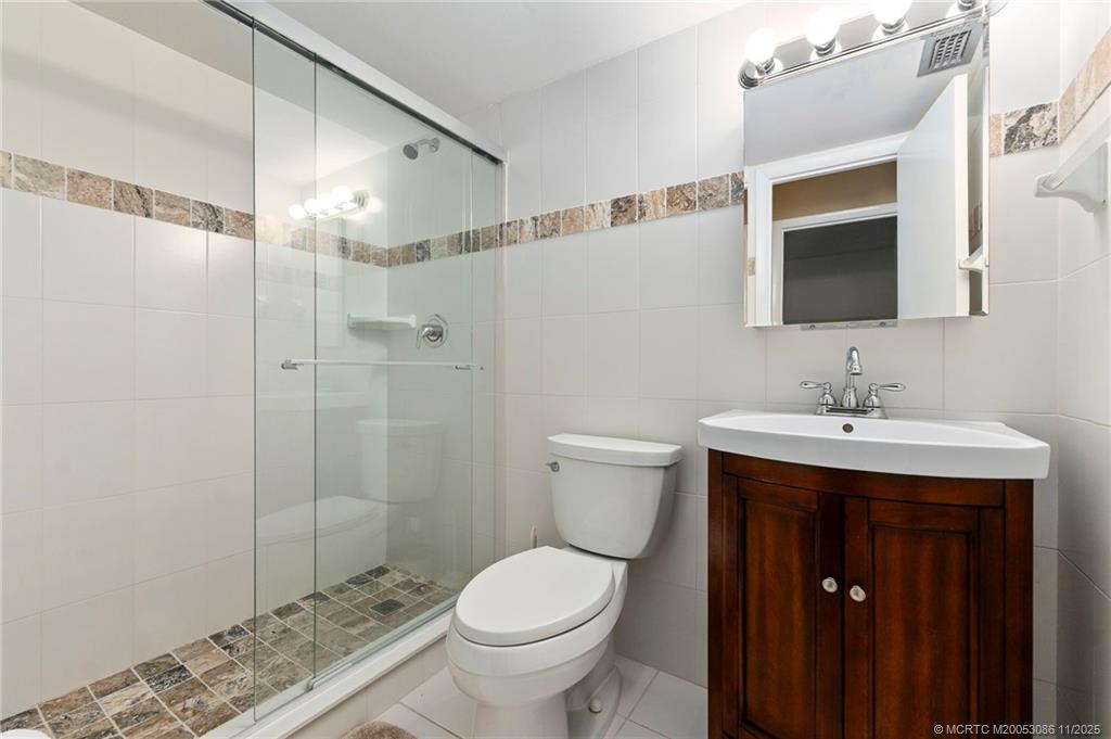 1951 Southwest Palm City Road, Unit 26F Stuart, FL 34994 - Photo 9 of 20 a bathroom with a sink toilet and shower