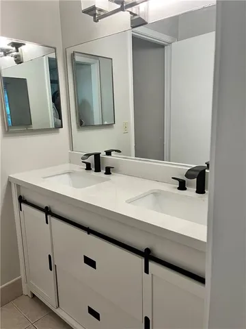 a bathroom with a sink vanity and mirror