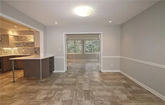 a view of a hallway with wooden floor and closet