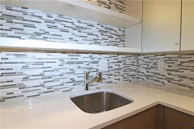 a kitchen with a sink and cabinets