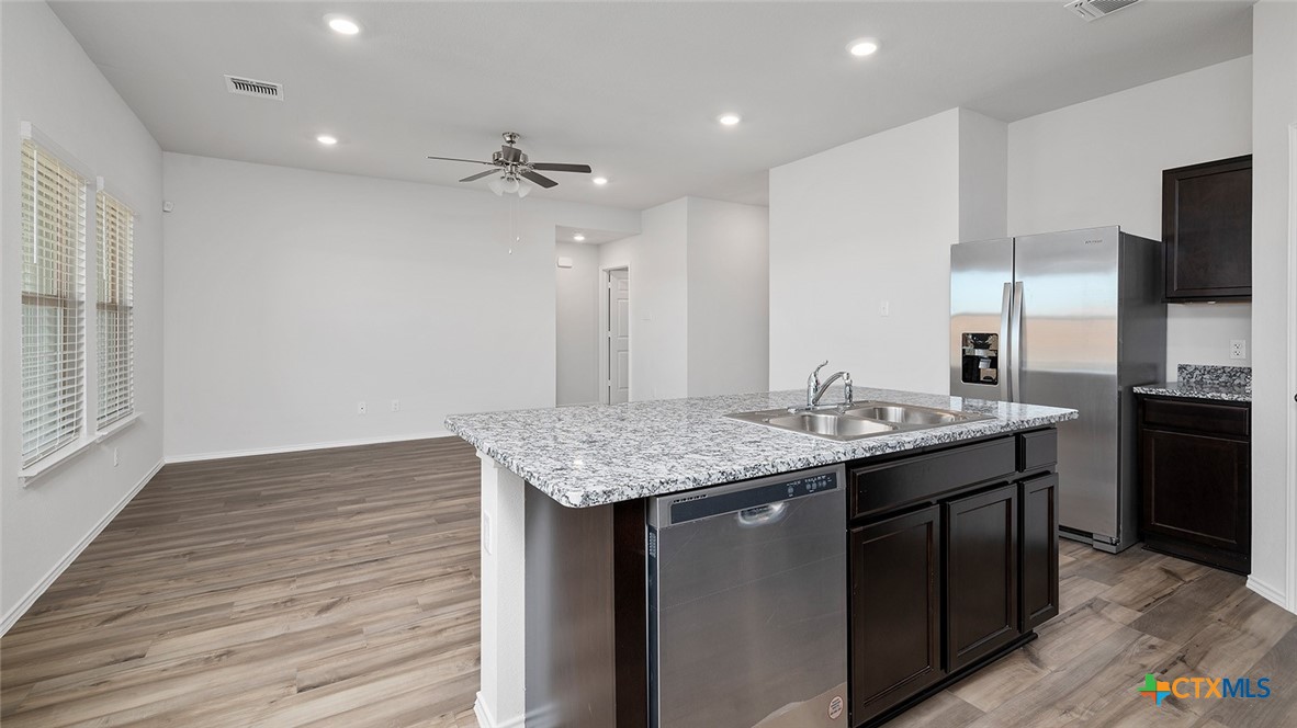 2317 Saffron Road Temple, TX 76501 - Photo 4 of 22 a kitchen with a sink and refrigerator
