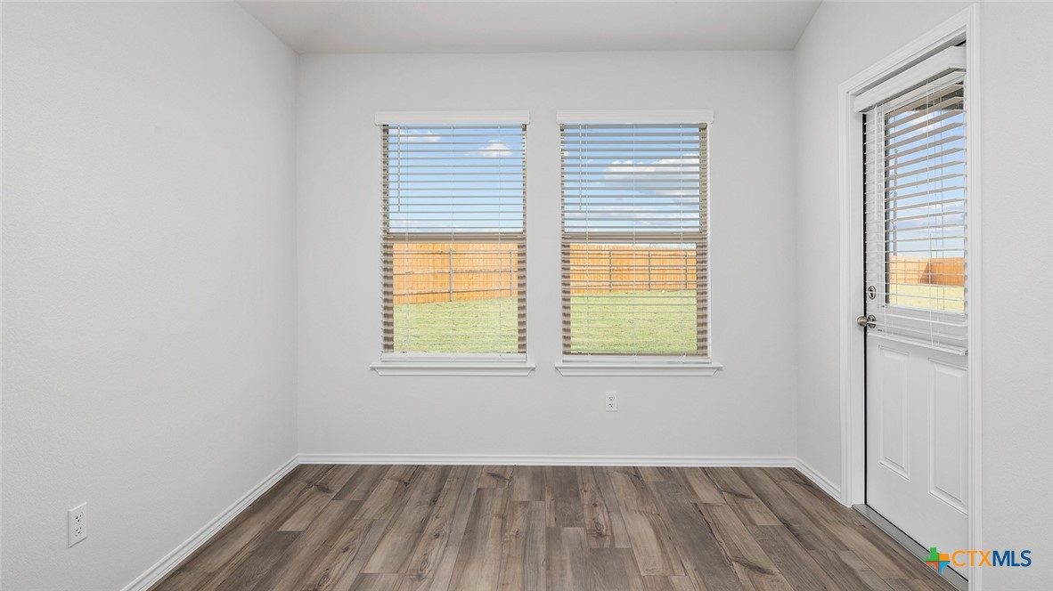 2317 Saffron Road Temple, TX 76501 - Photo 8 of 22 an empty room with wooden floor and windows