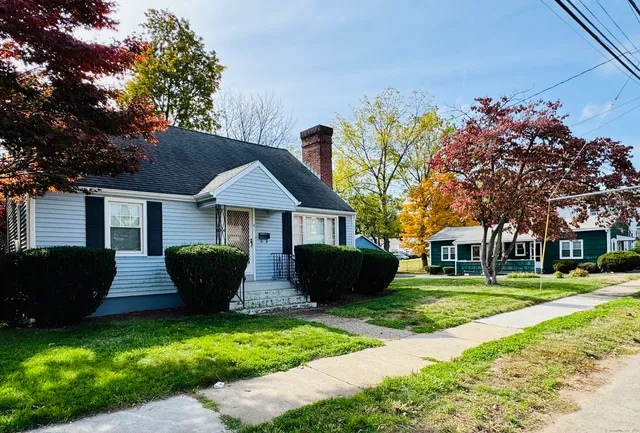 a front view of house with yard and green space