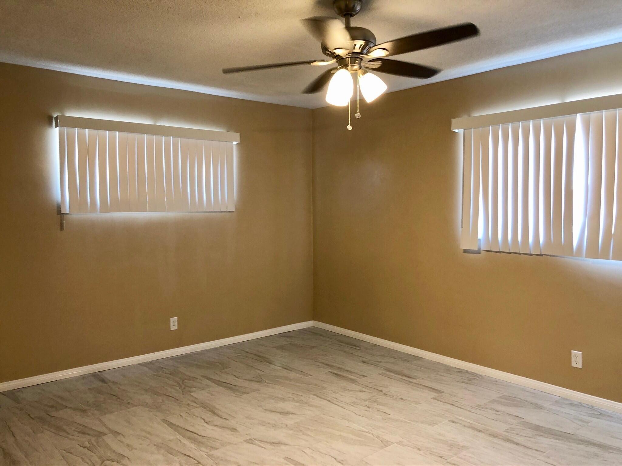 81104 Francis Avenue Indio, CA 92201 - Photo 12 of 23 an empty room with a window and a fan