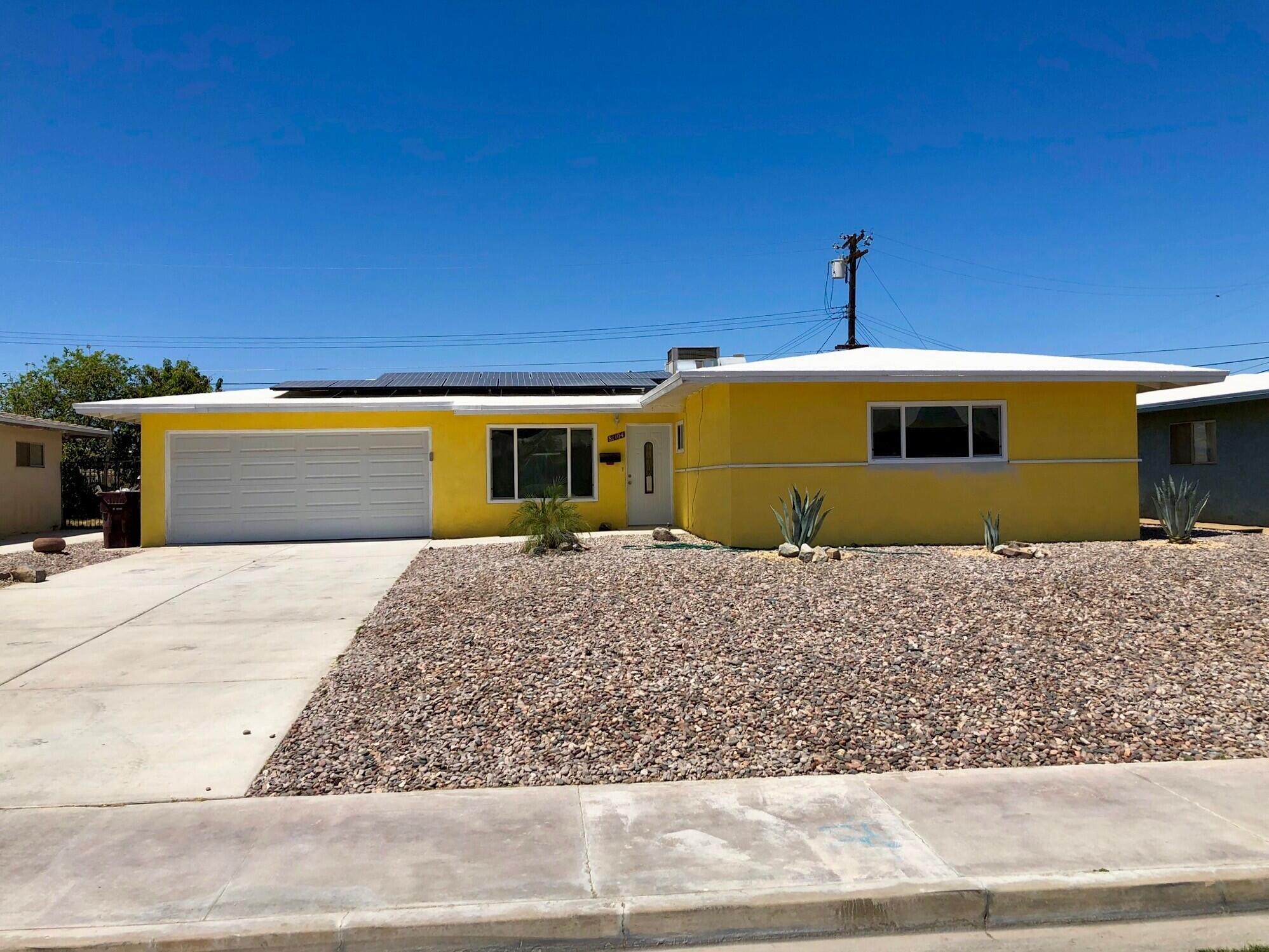 81104 Francis Avenue Indio, CA 92201 - Photo 2 of 23 a front view of a house with a yard