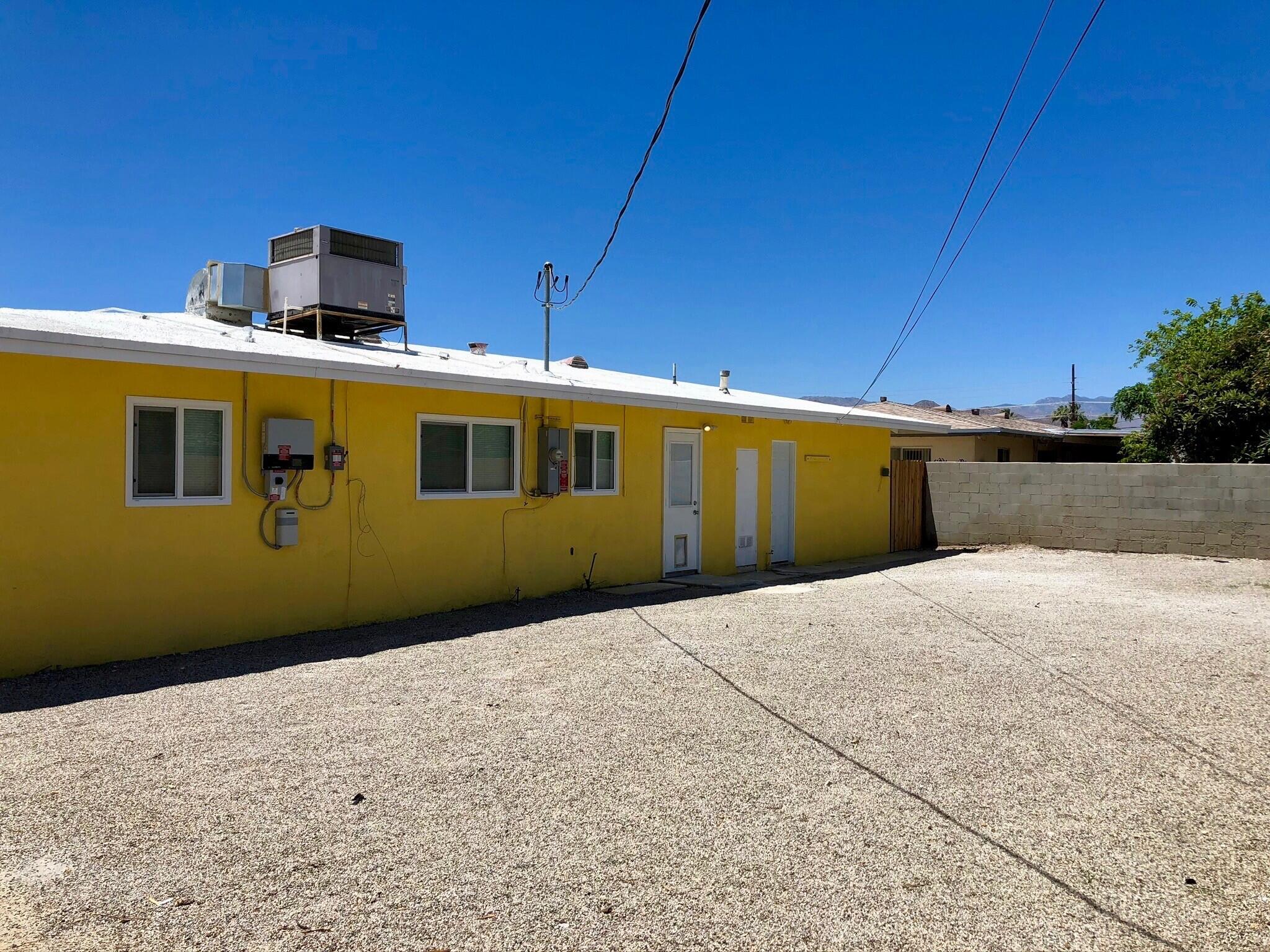 81104 Francis Avenue Indio, CA 92201 - Photo 22 of 23 a front view of a house with a yard