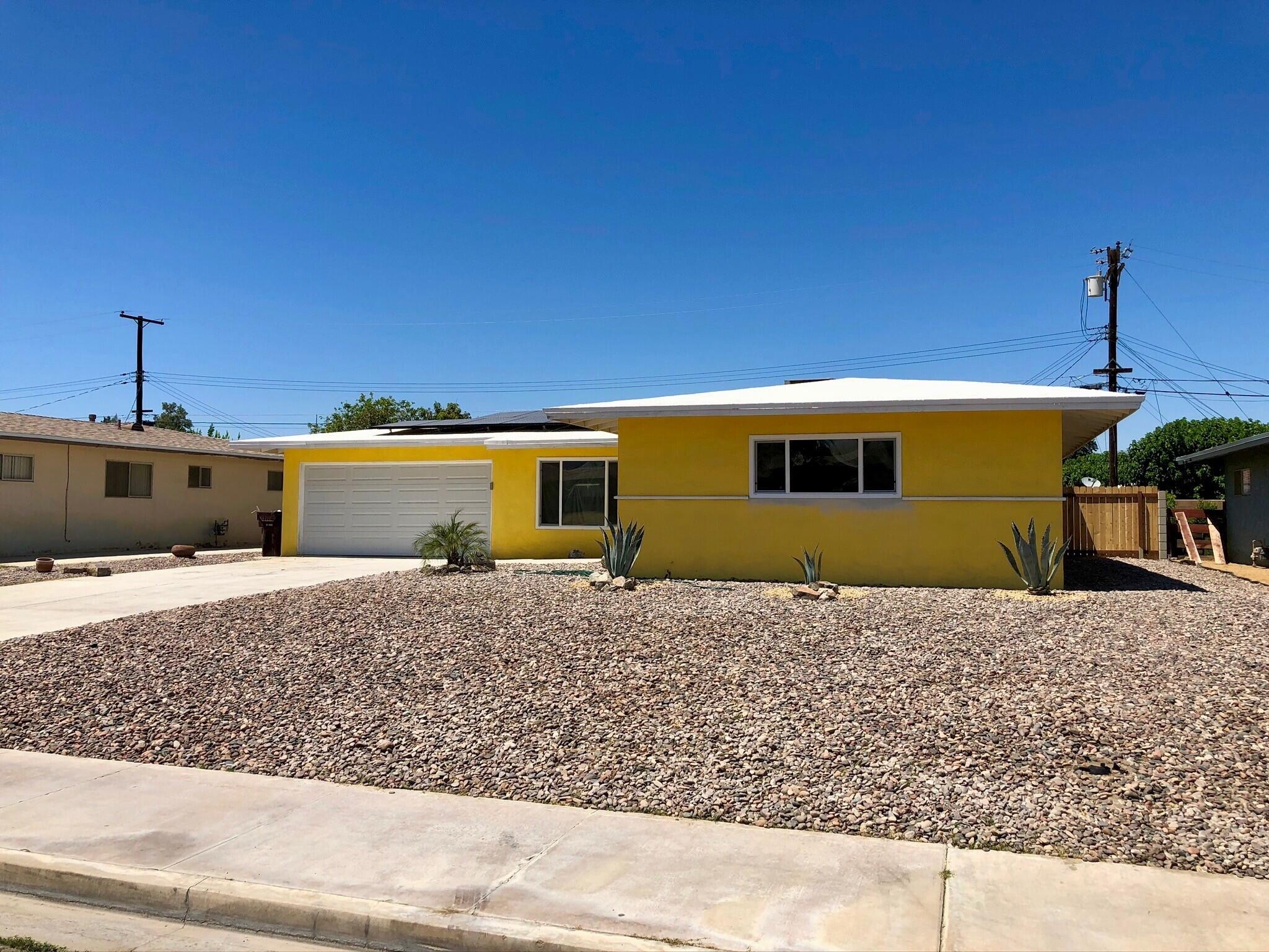 81104 Francis Avenue Indio, CA 92201 - Photo 23 of 23 a front view of a house with a yard