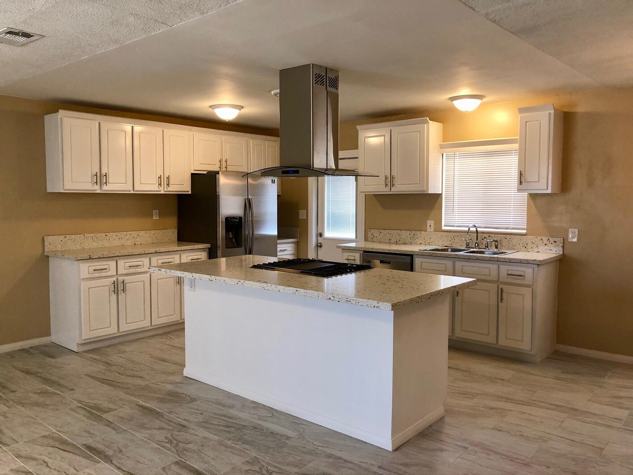 81104 Francis Avenue Indio, CA 92201 - Photo 7 of 23 a kitchen with stainless steel appliances granite countertop a sink stove and refrigerator