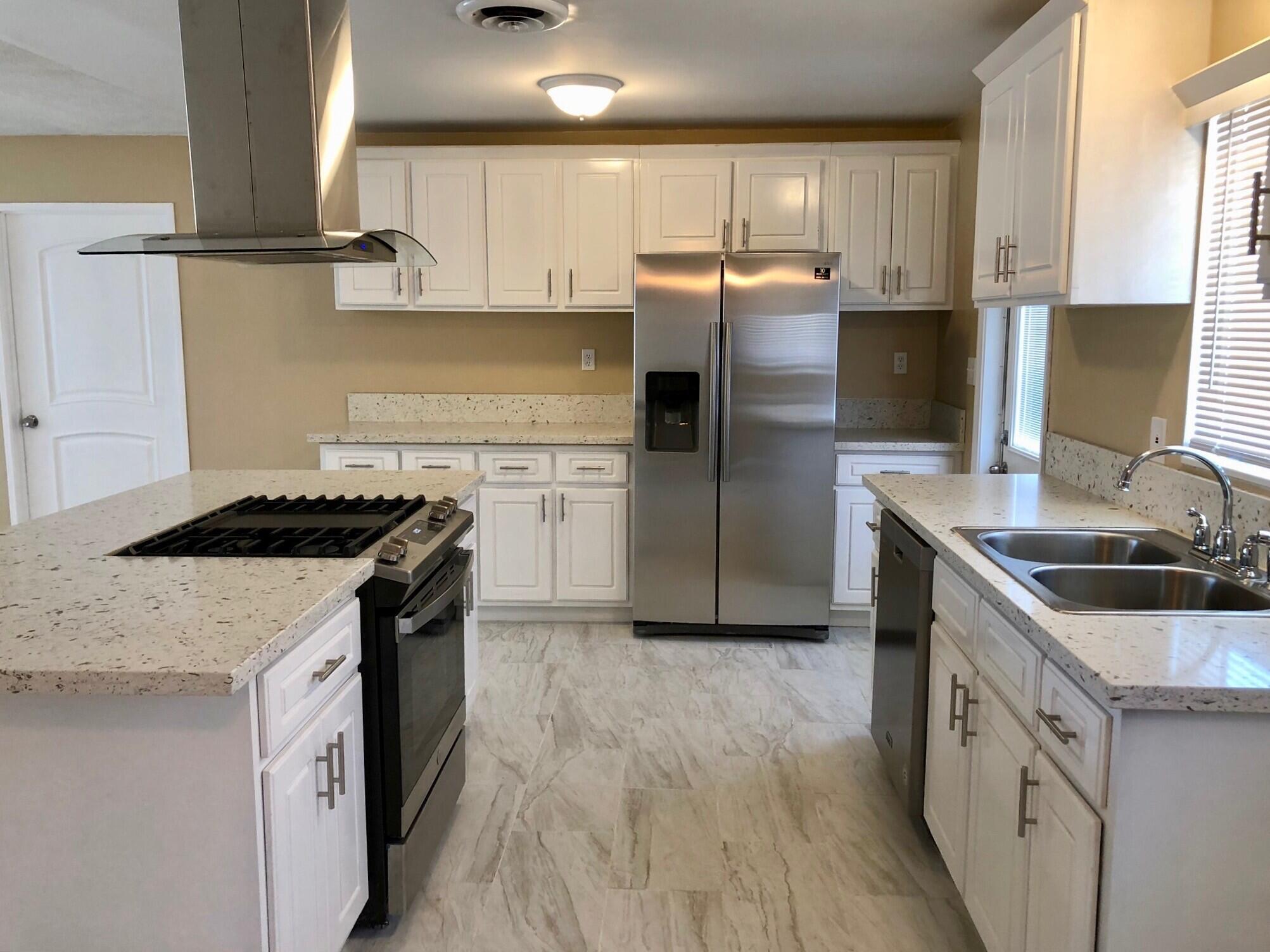 81104 Francis Avenue Indio, CA 92201 - Photo 8 of 23 a kitchen with stainless steel appliances granite countertop a sink stove and refrigerator
