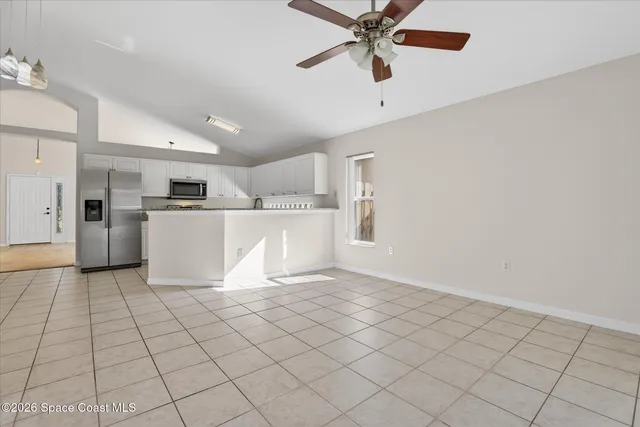 a view of a kitchen with a sink and a refrigerator