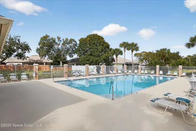 a view of a swimming pool with a lawn chairs