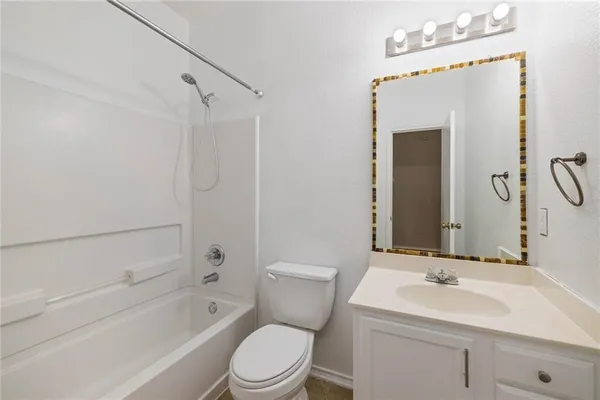 an empty room with a window and a ceiling fan