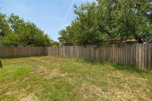 a view of outdoor space with wooden fence