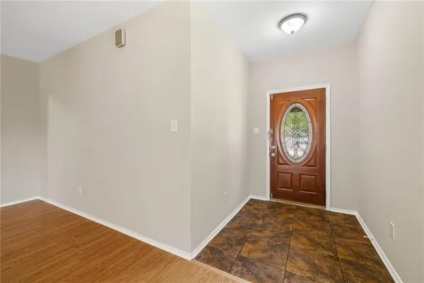a view of a room with wooden floor