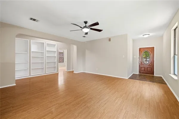 wooden floor in an empty room with a window