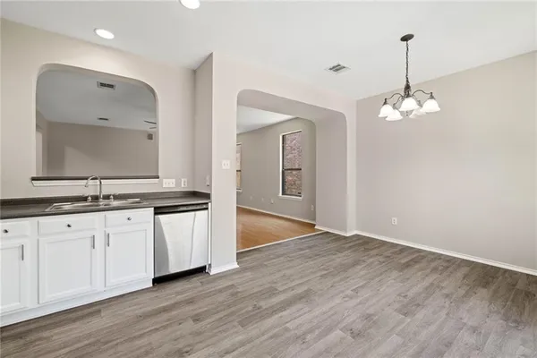 a large kitchen with kitchen island a sink stainless steel appliances and cabinets