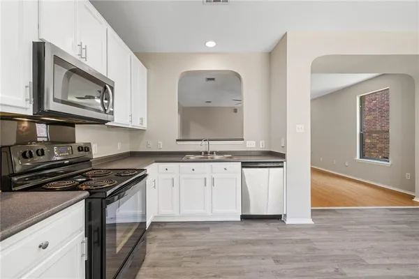 a bathroom with granite countertop a sink and a mirror