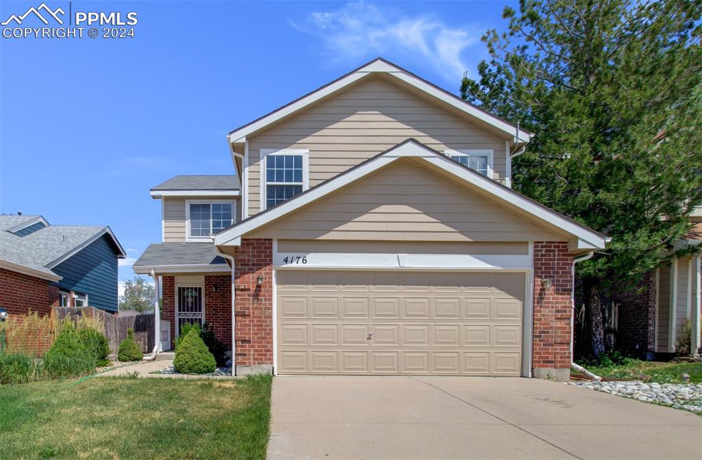 4176 South Himalaya Way Aurora, CO 80013 - Photo 1 of 27 View of front property featuring a garage and a front lawn